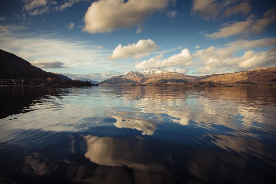 Still water and hills on Loch Lomond at first light